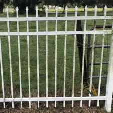 Transforming-a-White-Metal-Fence-from-Algea-Coated-to-Shiny-and-Crisp-Clean-A-Pressure-Washing-Soft-Washing-Success-in-New-Smyrna-Beach-Florida 0